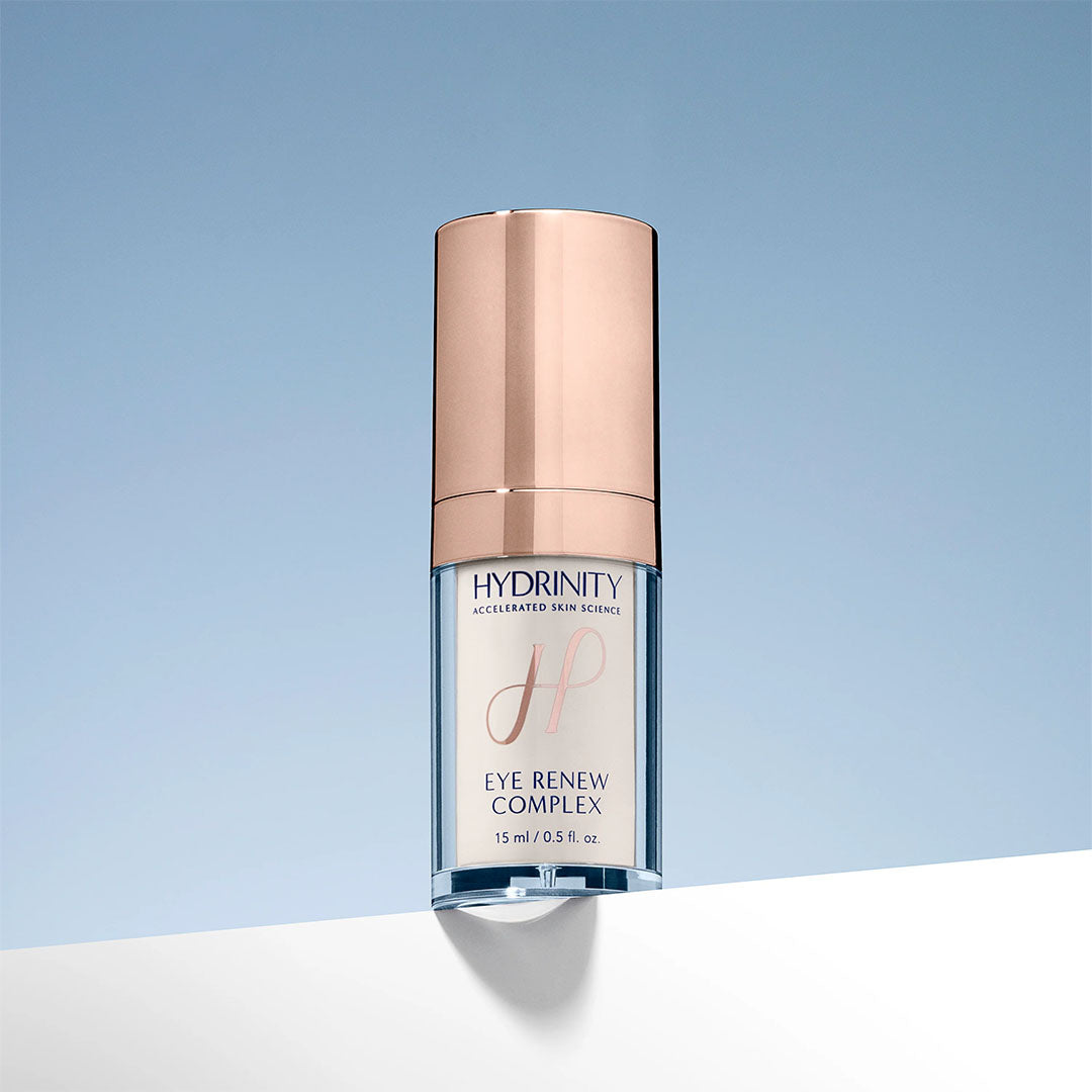 Hydrinity Eye Renew Complex, a clear and rose gold pump bottle with white serum, 15ml.