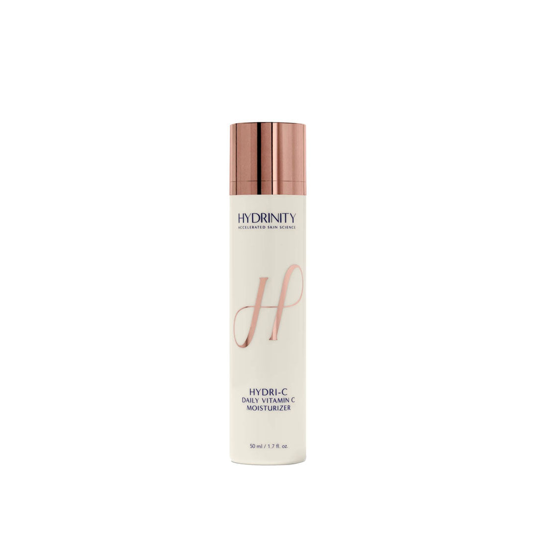 White HYDRINITY HYDRI-C Daily Vitamin C Moisturizer bottle with rose gold pump and "H" logo.