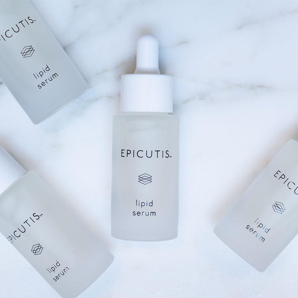 EPICUTIS Lipid Serum in a frosted glass dropper bottle, surrounded by three flat bottles, on marble.