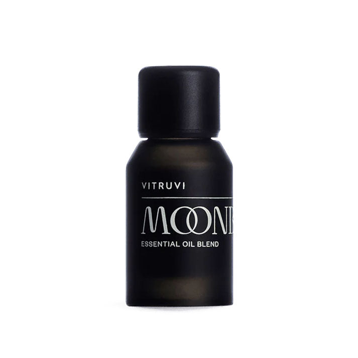 Small, matte black Vitruvi Moonbeam Essential Oil Blend bottle with a matching cap.