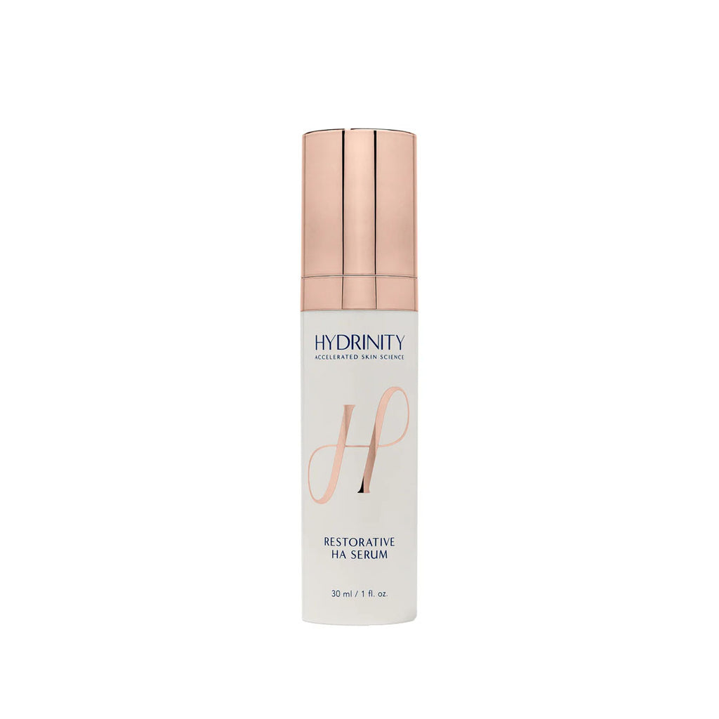 White bottle of Hydrinity Restorative HA Serum with a rose gold pump top, 30 ml / 1 fl. oz.