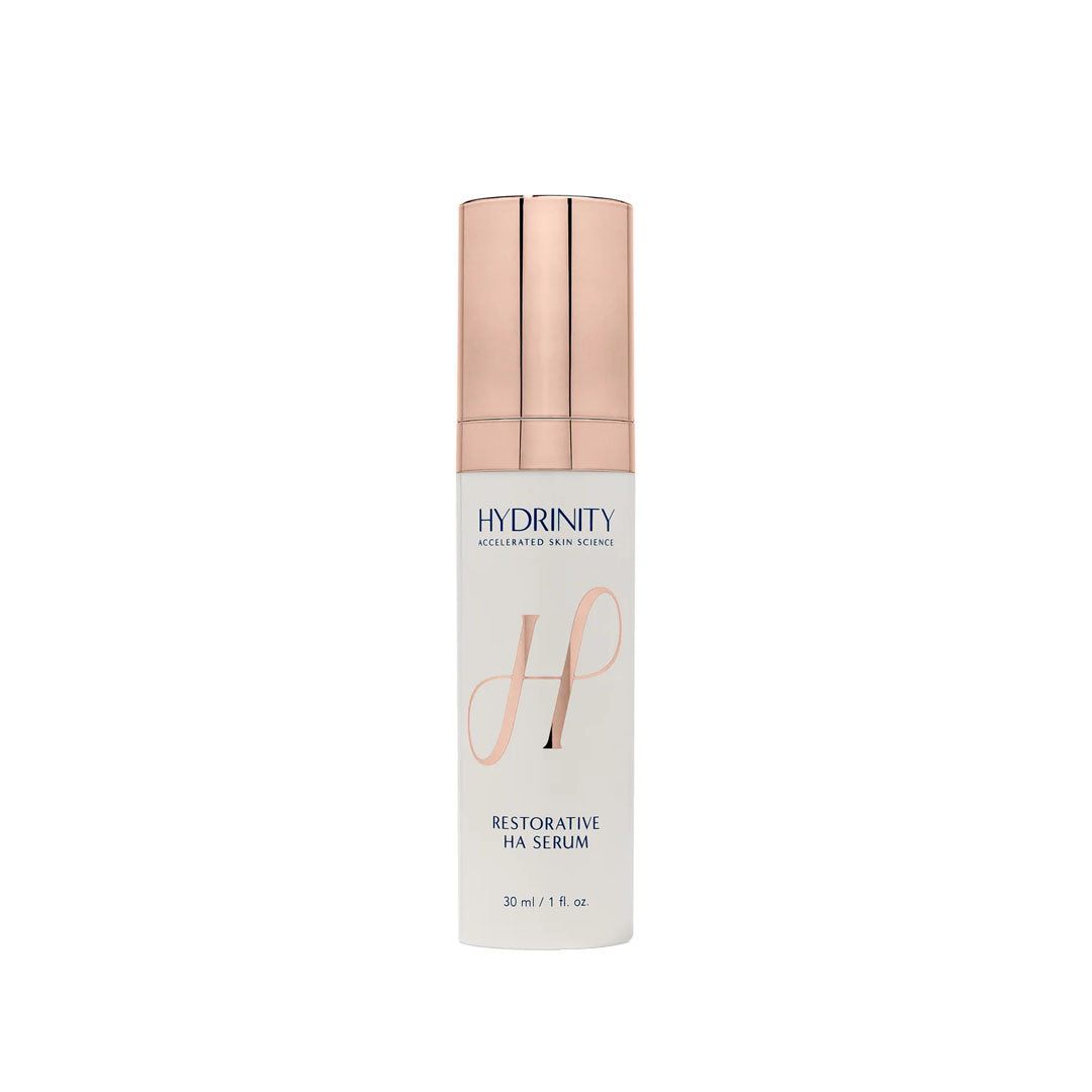 White bottle of Hydrinity Restorative HA Serum with a rose gold pump top, 30 ml / 1 fl. oz.