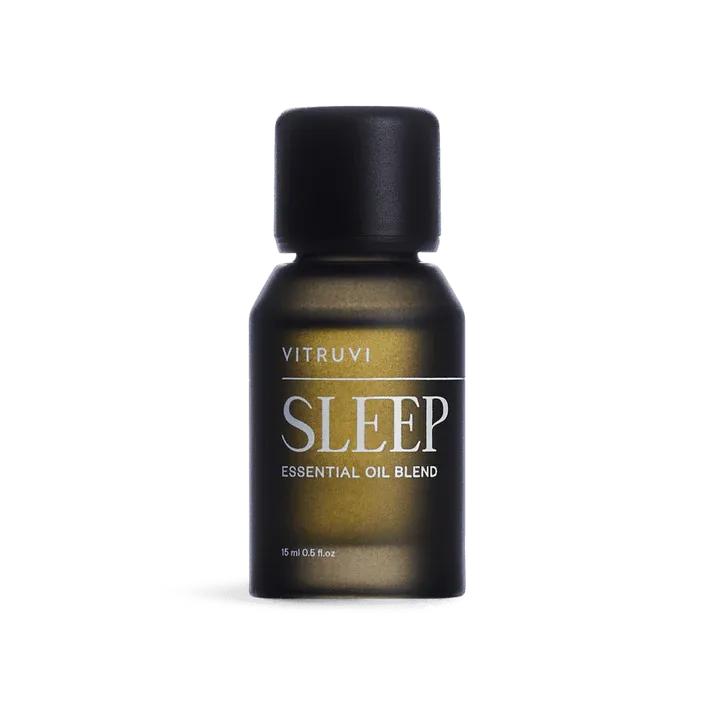 Vitruvi Sleep essential oil blend in a small, dark amber glass bottle with a black cap.