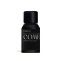 Vitruvi Comfort Diffuser Blend in a small, dark amber glass bottle with a matte black cap and label.