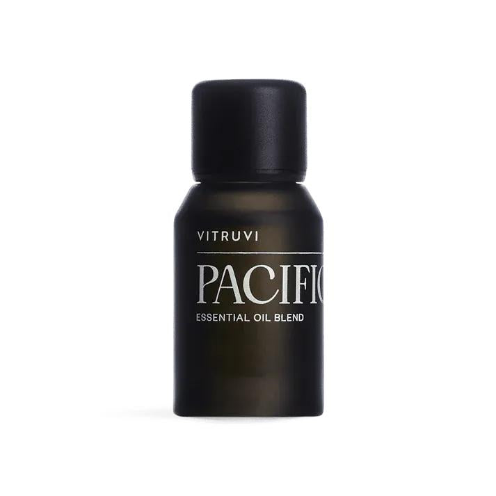 Vitruvi Pacific Diffuser Blend: a small, dark brown essential oil bottle with a black cap and white text.