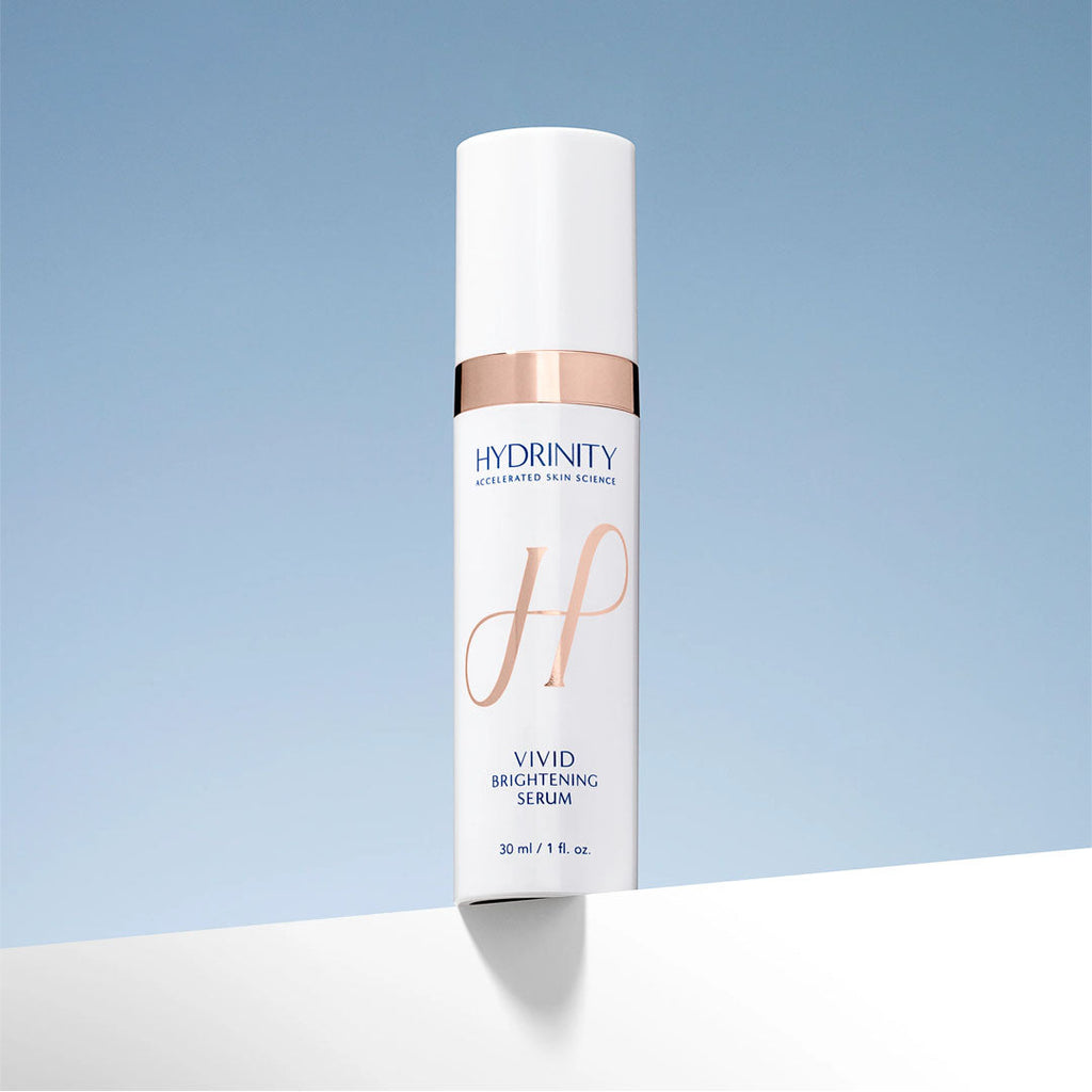 Hydrinity Vivid Brightening Serum in a white and rose gold pump bottle, 30ml size.