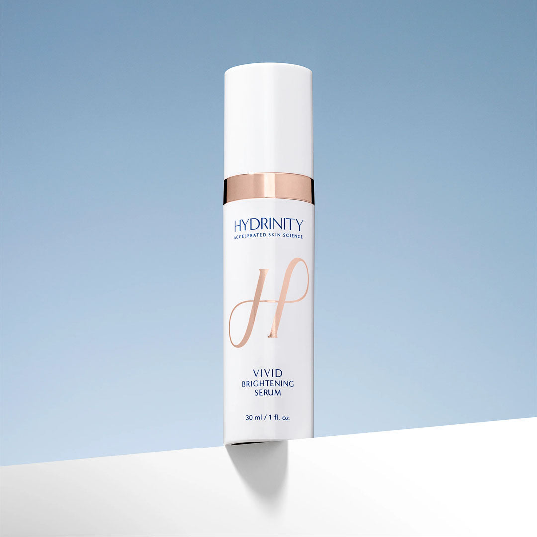 Hydrinity Vivid Brightening Serum in a white and rose gold pump bottle, 30ml size.
